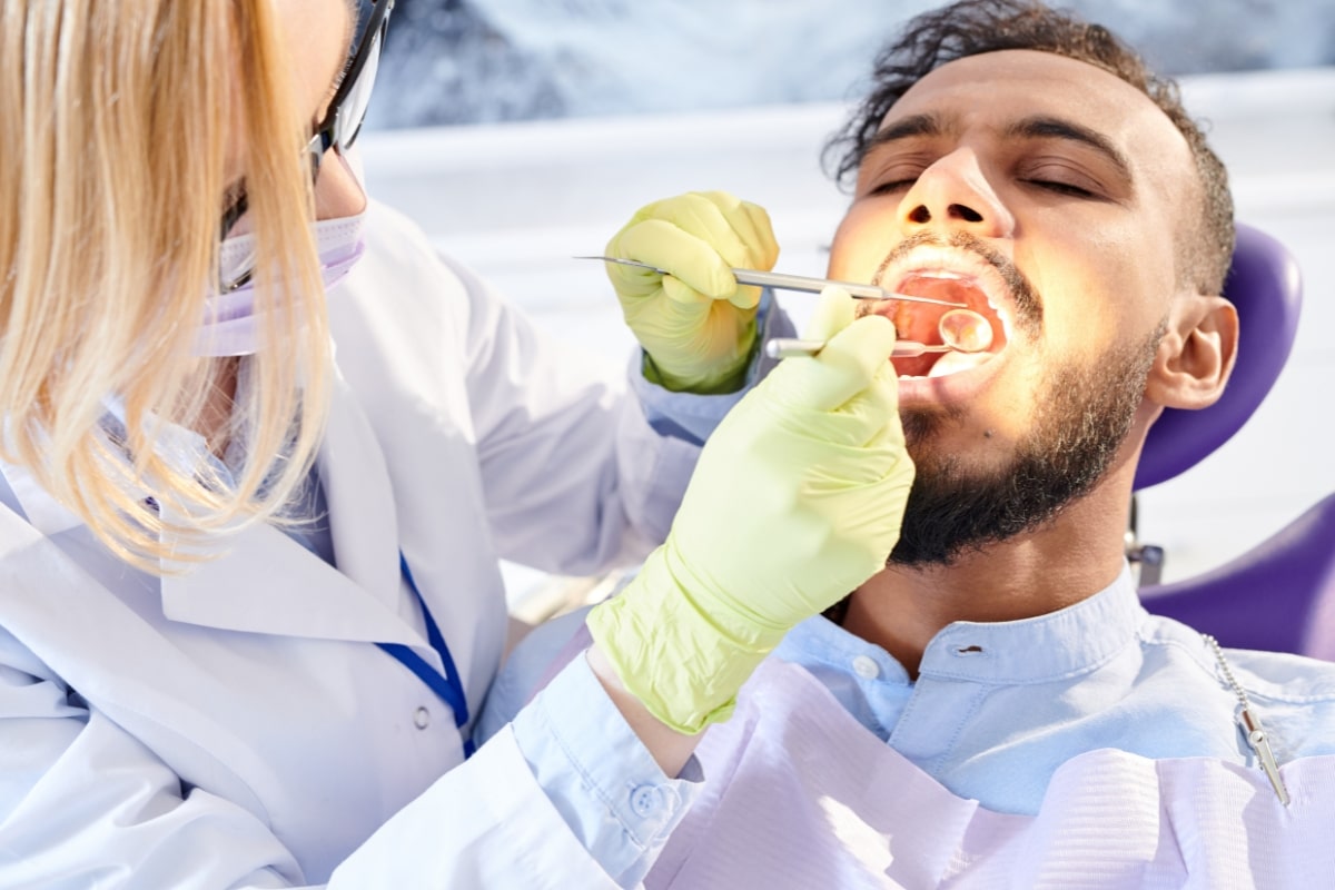 Dentist examining a patient for signs of a cavity or tooth infection
